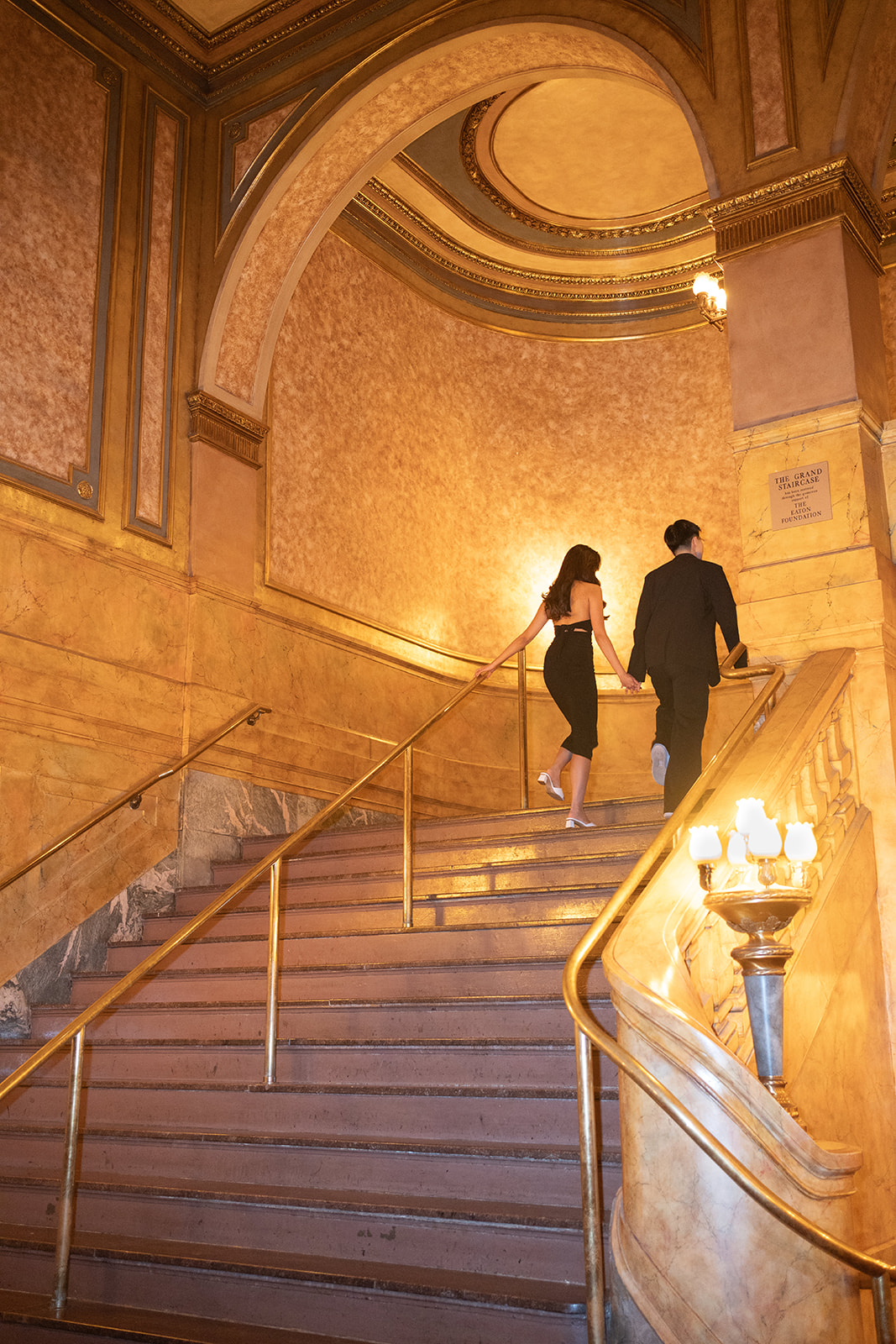 Bryan and Sheryl walking up the golden staircase